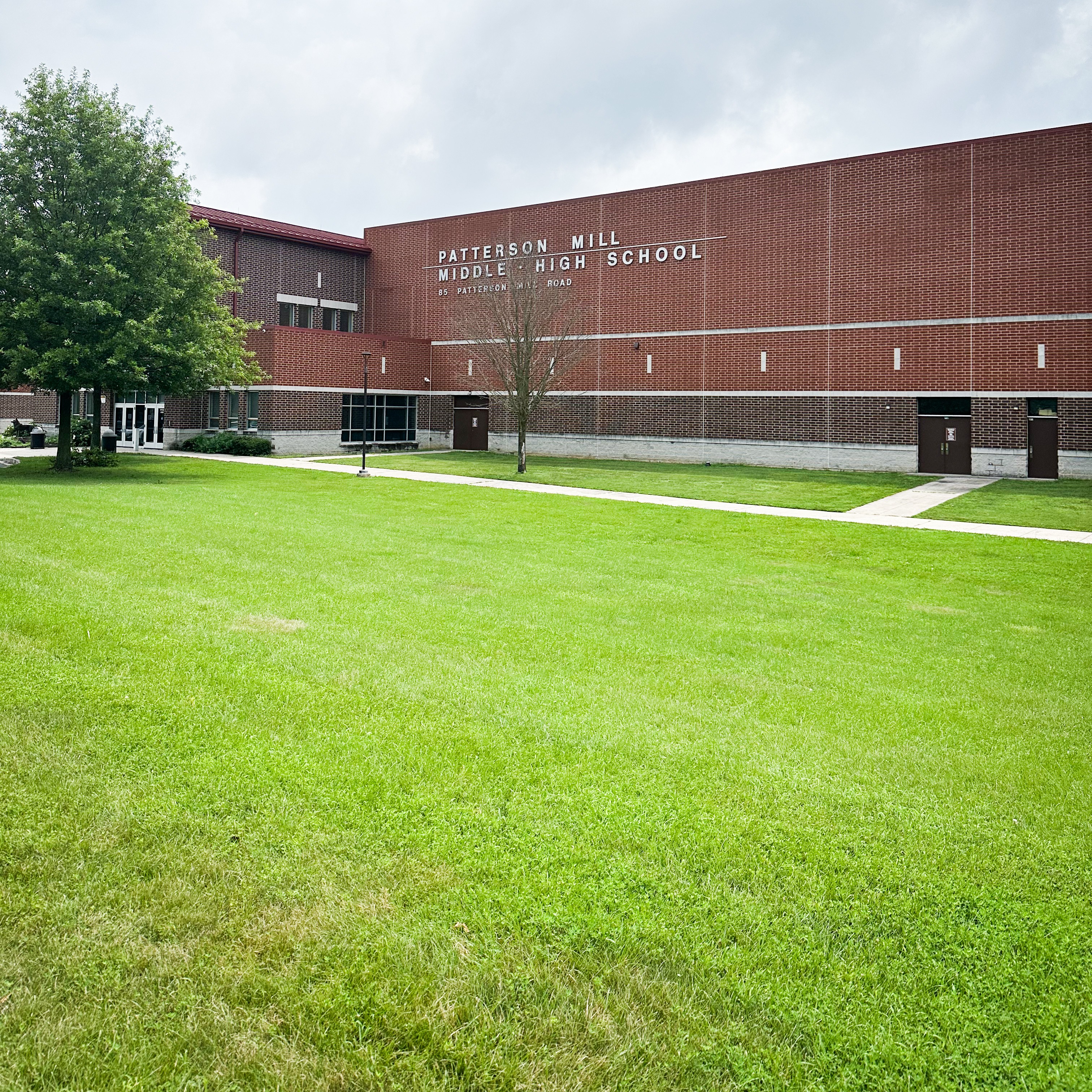 Front of the Patterson Mill building showing main entrance and school name with address
