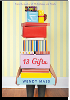 A stack of colorful gift boxes is held by a pair of legs, with a striped wall in the background, promoting the book '13 Gifts' by Wendy Mass.