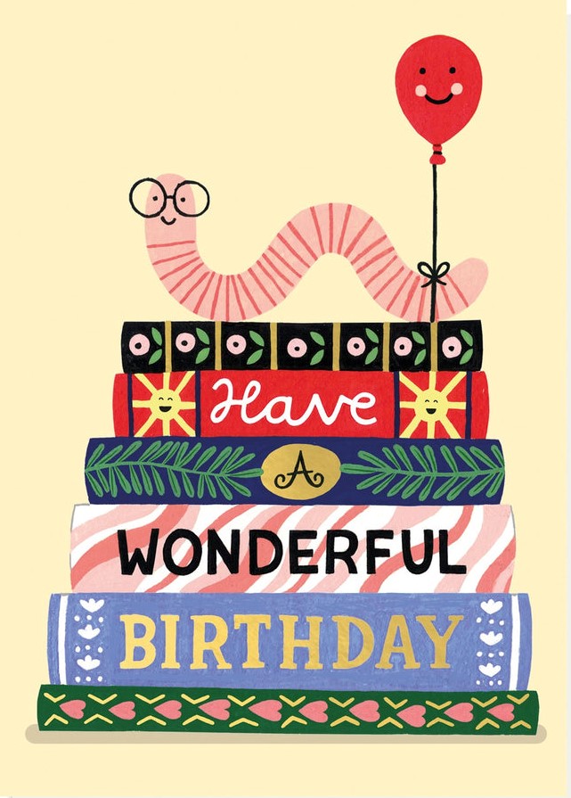 A cheerful illustration featuring a cartoon worm wearing glasses, sitting atop a stack of colorful books with the text 'Have A WONDERFUL BIRTHDAY' prominently displayed, accompanied by a smiling balloon.