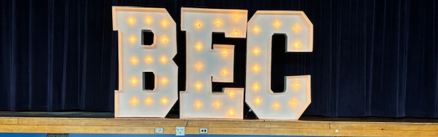 Large BEC letters on stage with dog in front 