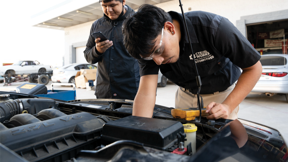 Automotive CTE student working on a car.