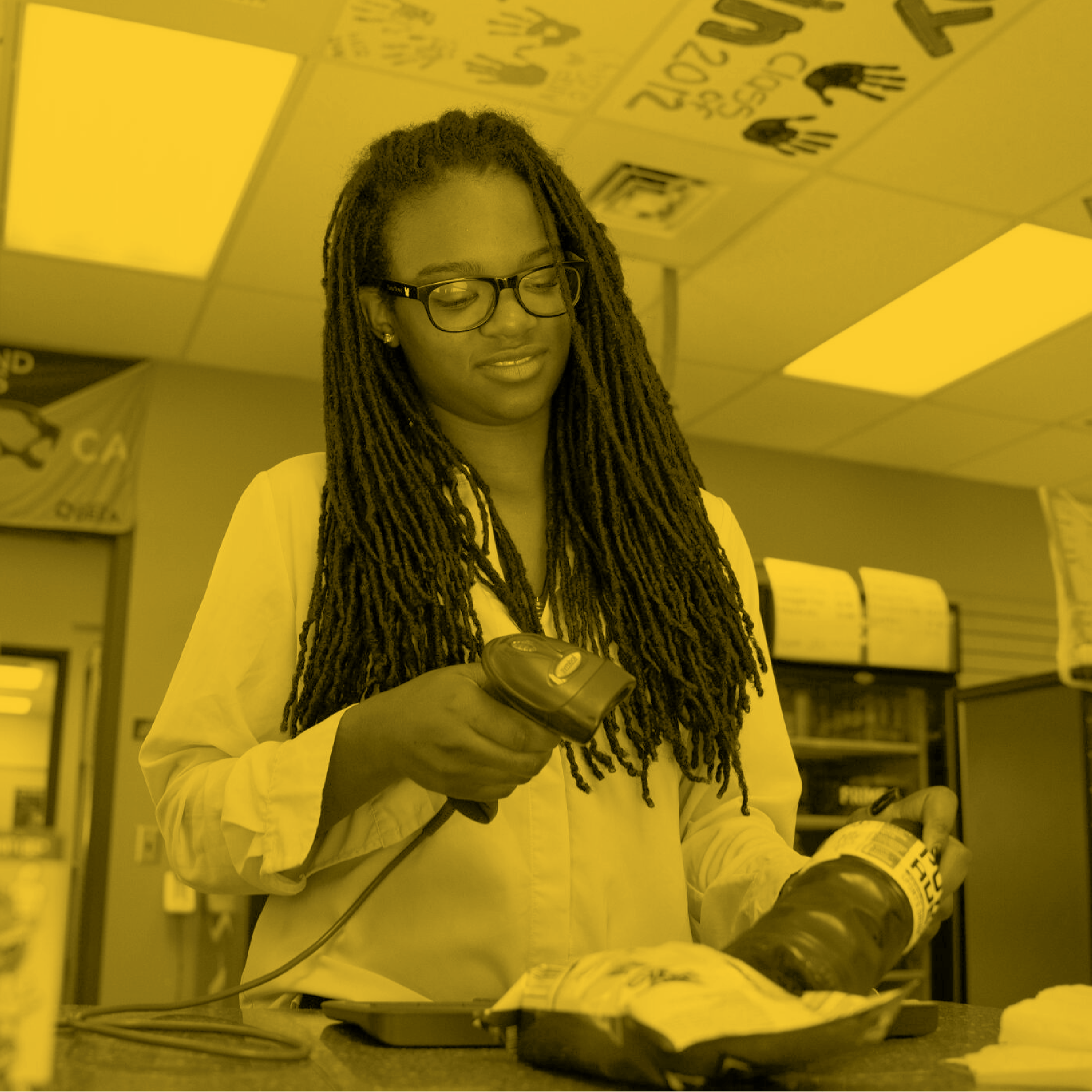Student scanning drink in school store