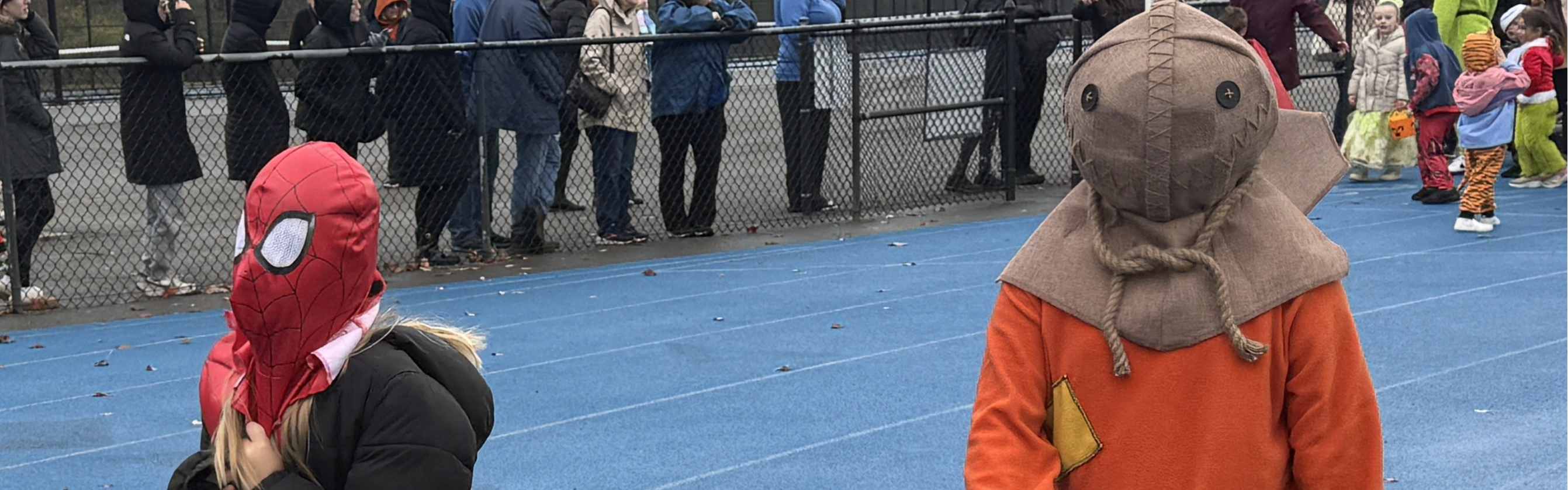 students walk in halloween parade in costume