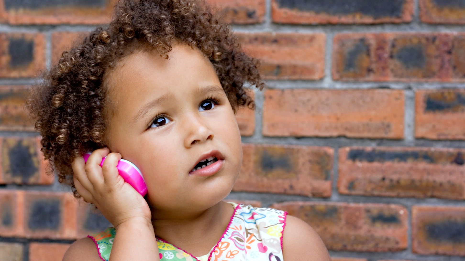 young girl using telephone