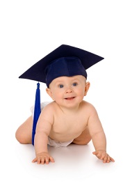 A smiling baby crawling while wearing a blue graduation cap.