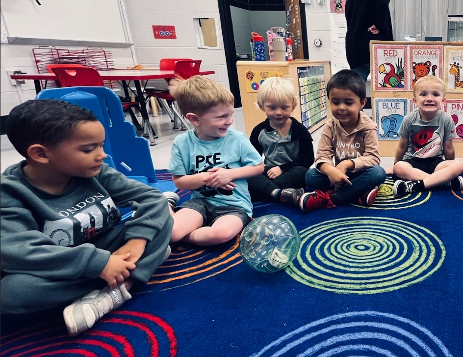 students sitting on a carpet