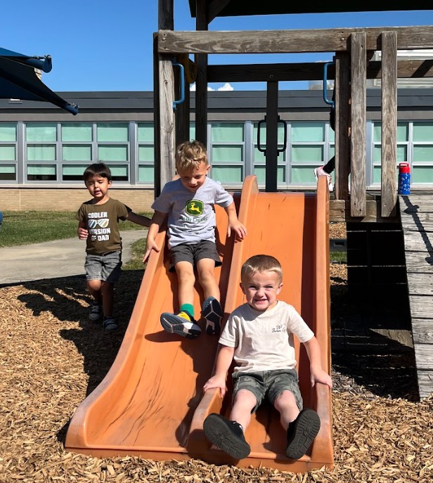 students on a slide outside