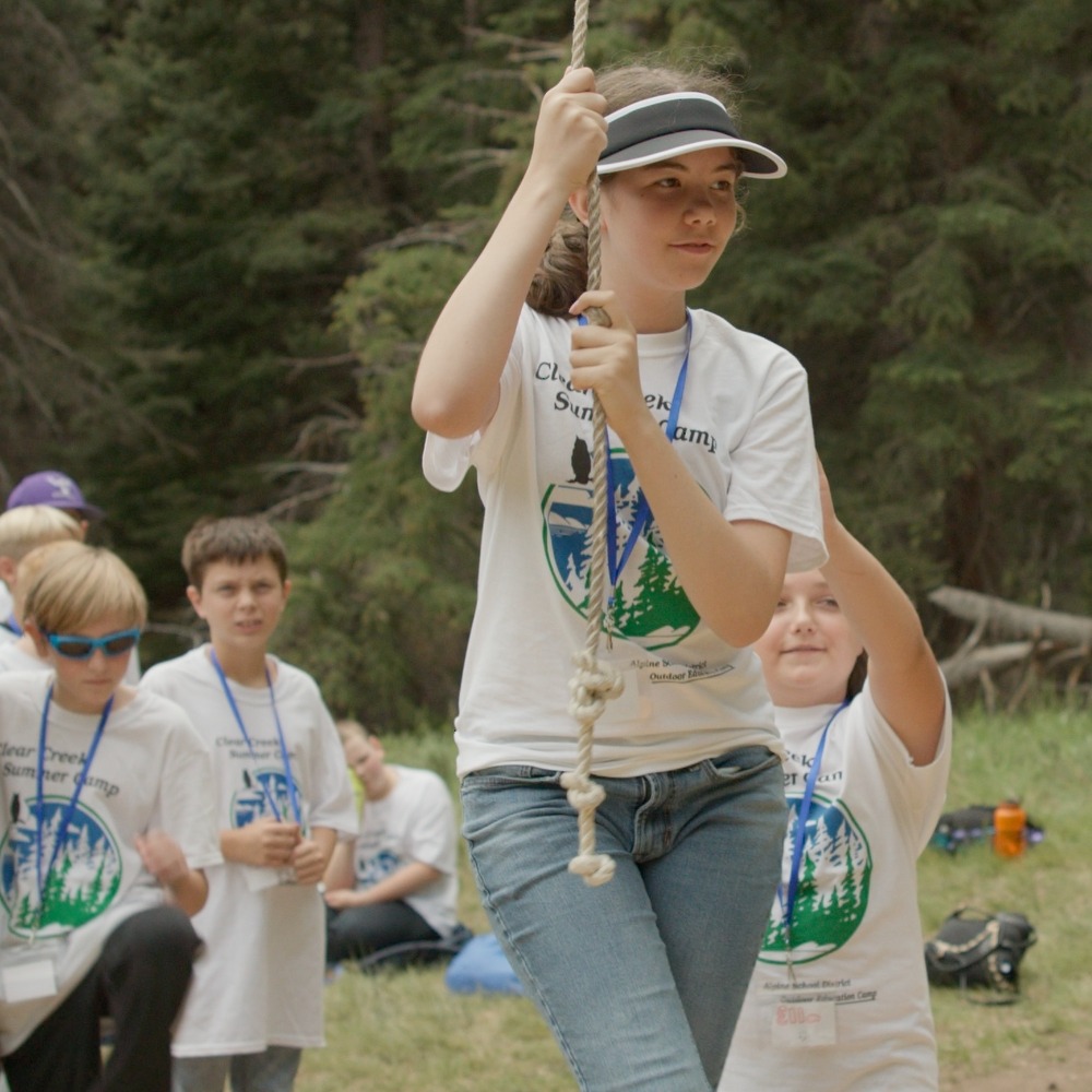 s girl holds a rope at the Clear Creek summer camp