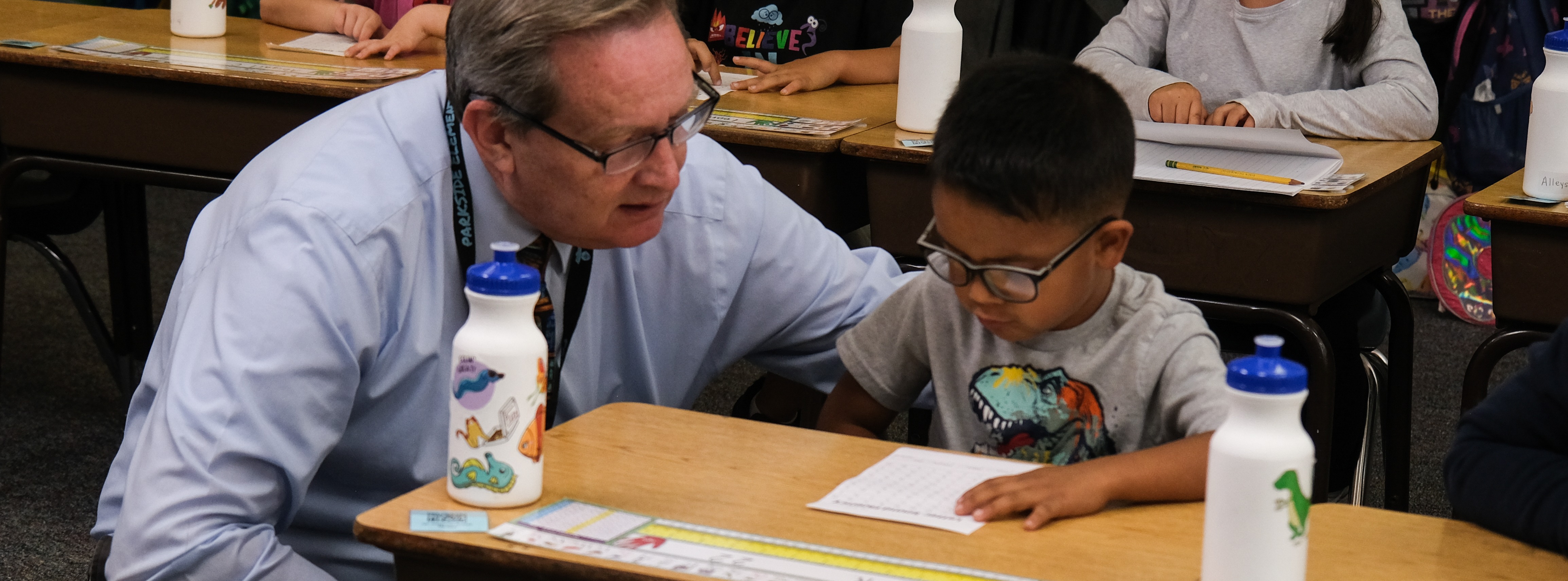principal John Shelton talking to a  young student