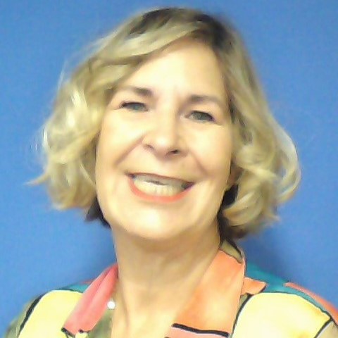 Smiling women with short blonde hair, blue background