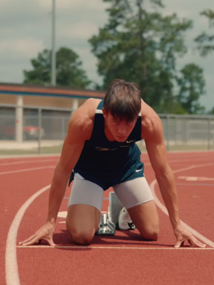 Male student at the starting line for a race on a track