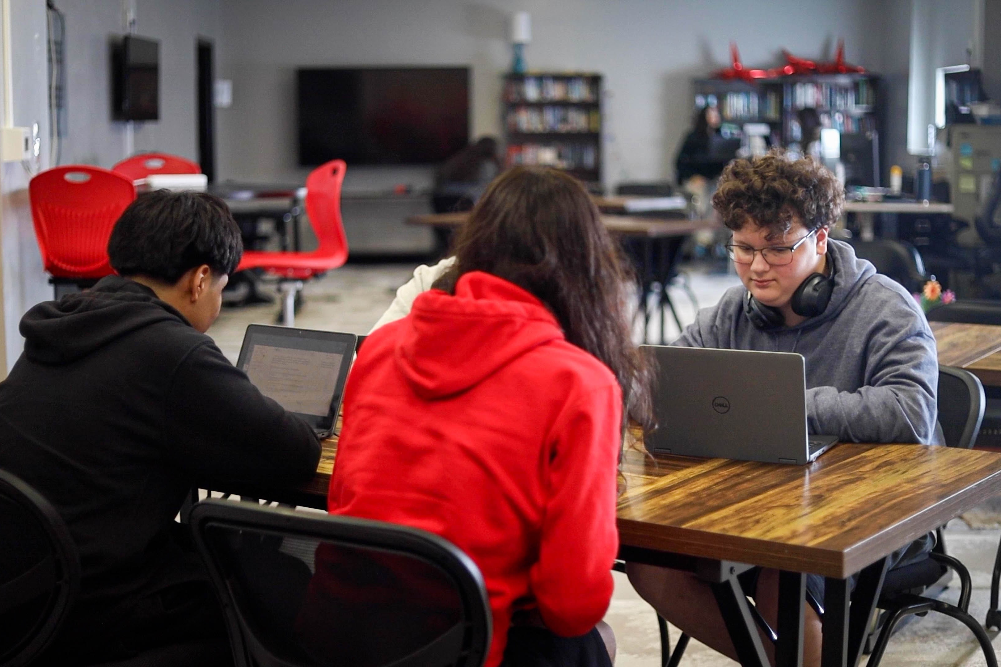 A group of students sit at a table.