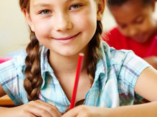 Girl smiling while writing