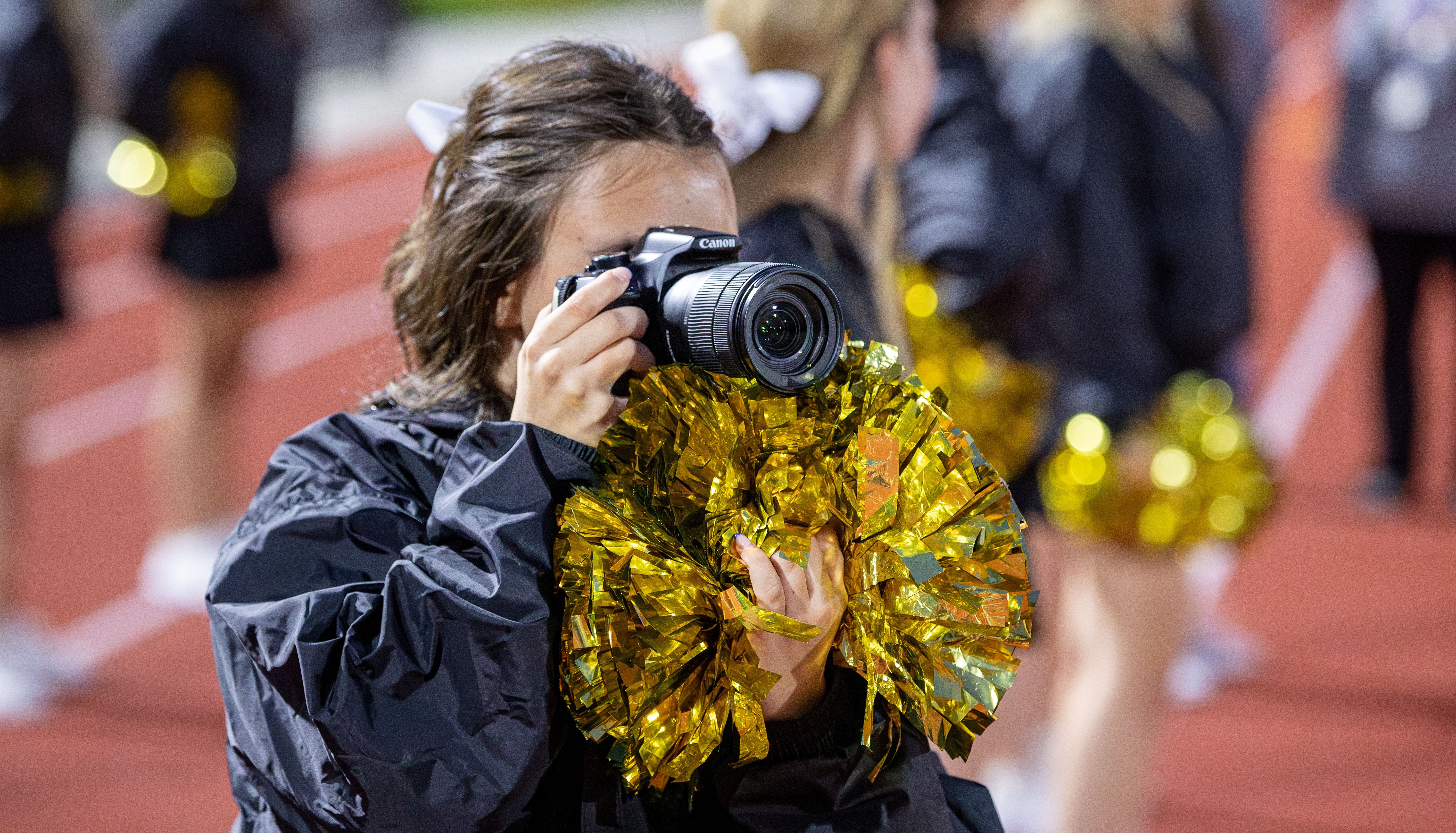 LHS poms taking picture at football game