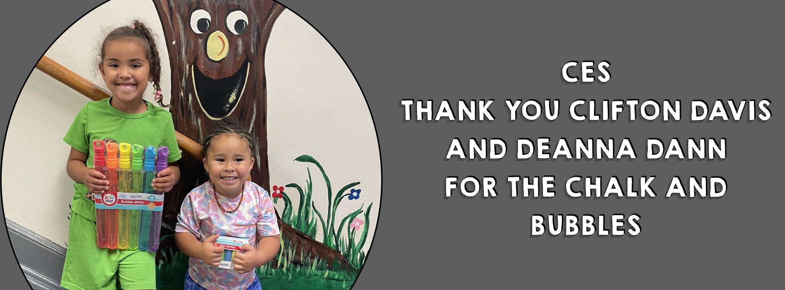 Two smiling children holding markers and bubbles stand by a painted tree mural. Text reads, "CES thank you Clifton Davis and Deanna Dann for the chalk and bubbles."