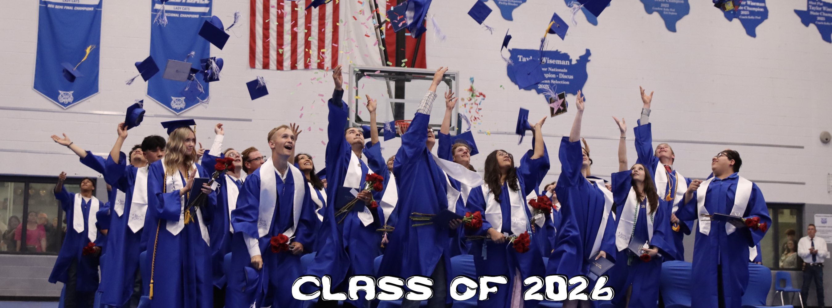 Senior group picture tossing their caps in the air from gradution Class of 2026