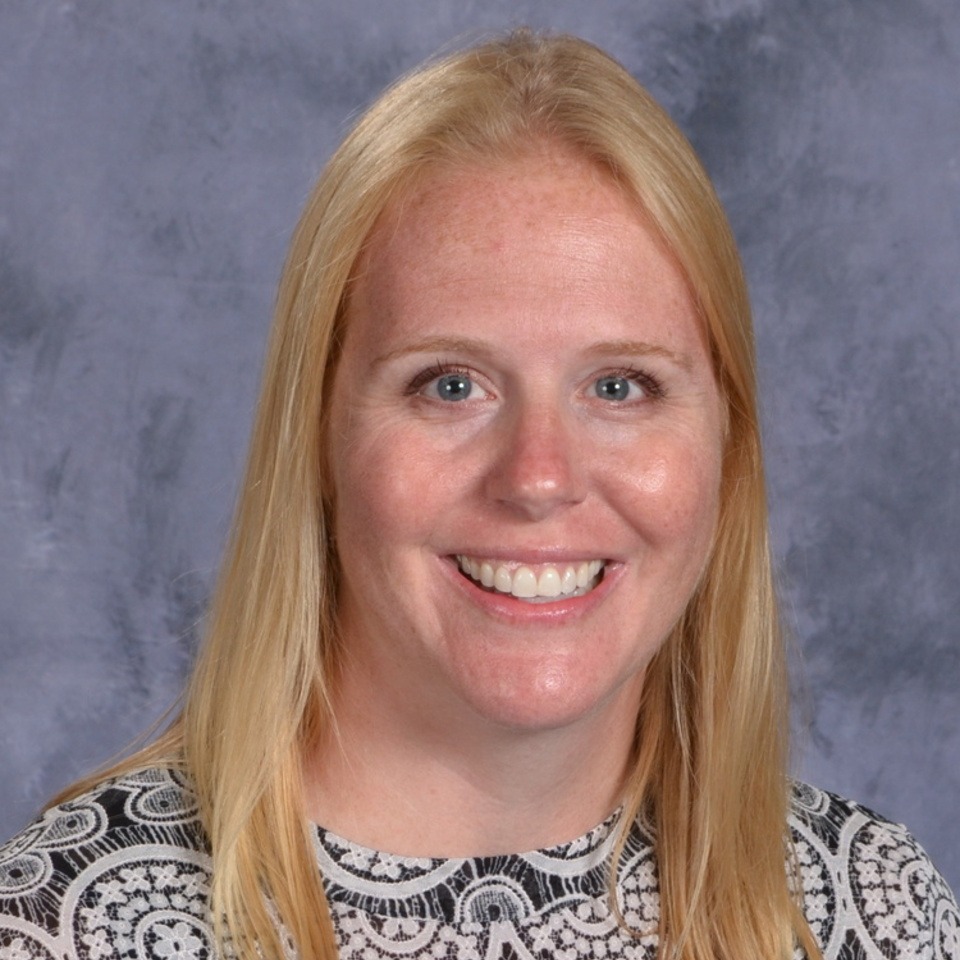 women with blond hair, black and white shirt, on grey background