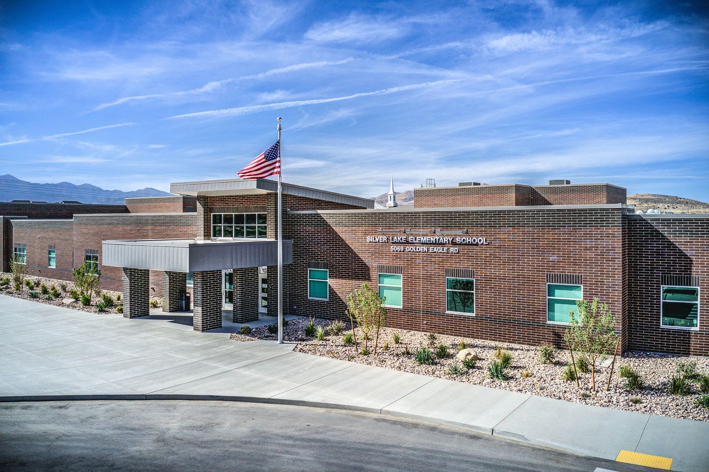 Picture of Silver Lake Elementary entrance with flag waving in the wind