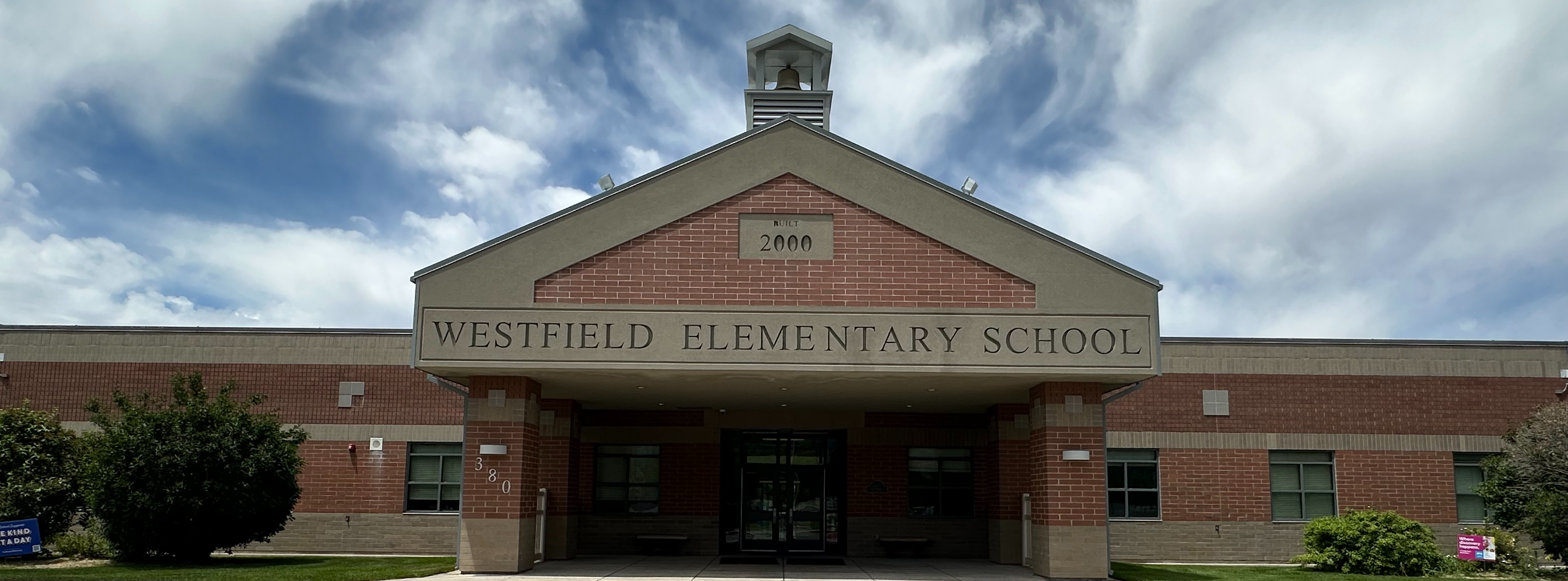 An image of the front of Westfield Elementary with a blue sky. 