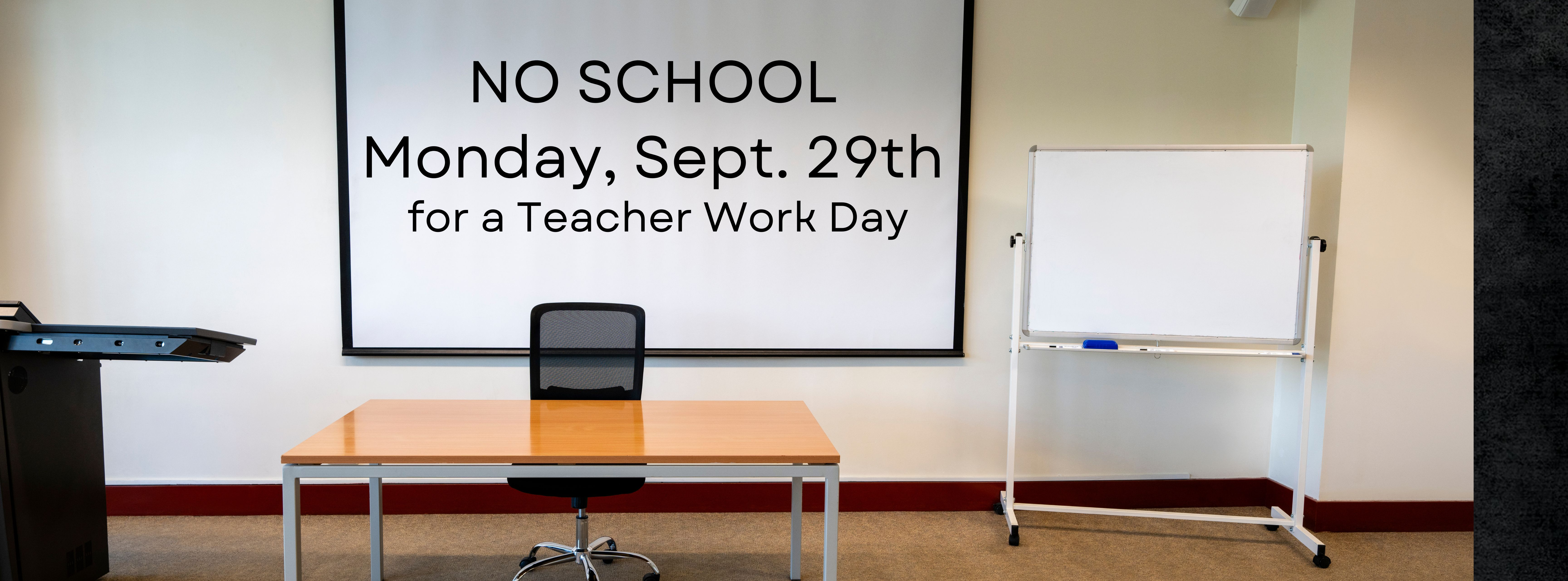 A classroom with writing on the whiteboard saying No School Monday 29th for a Teacher Work Day