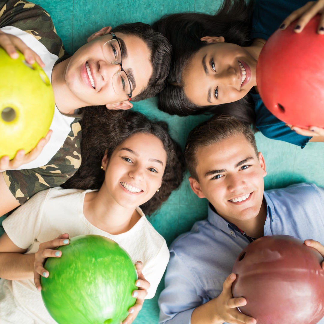 Group of teens with colorful bowling balls