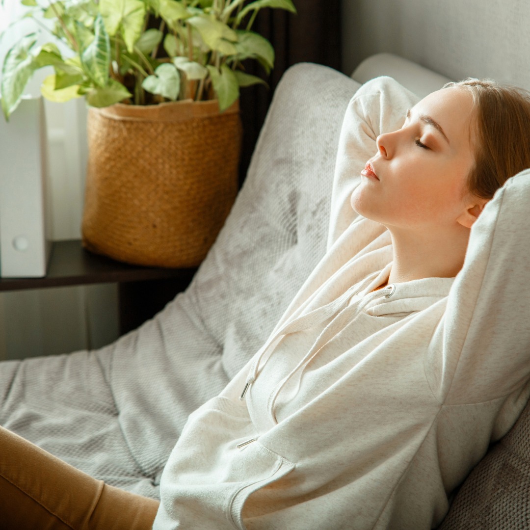 Female student relaxing on comfortable chair