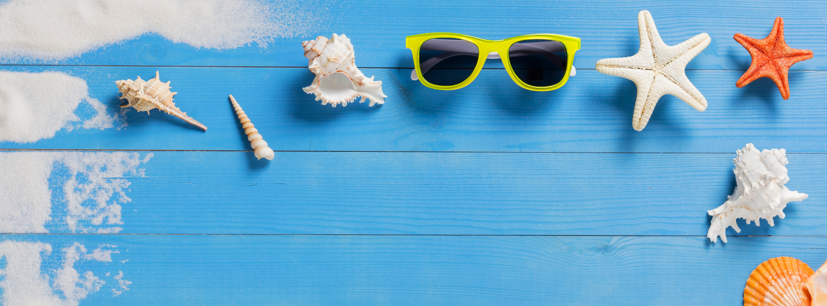 an image of sunglasses and seashells that invokes a feeling of summer vacation