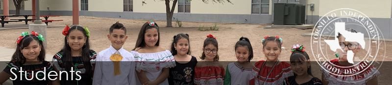 A group of children wearing traditional Mexican clothing smiles and poses together for a photo.