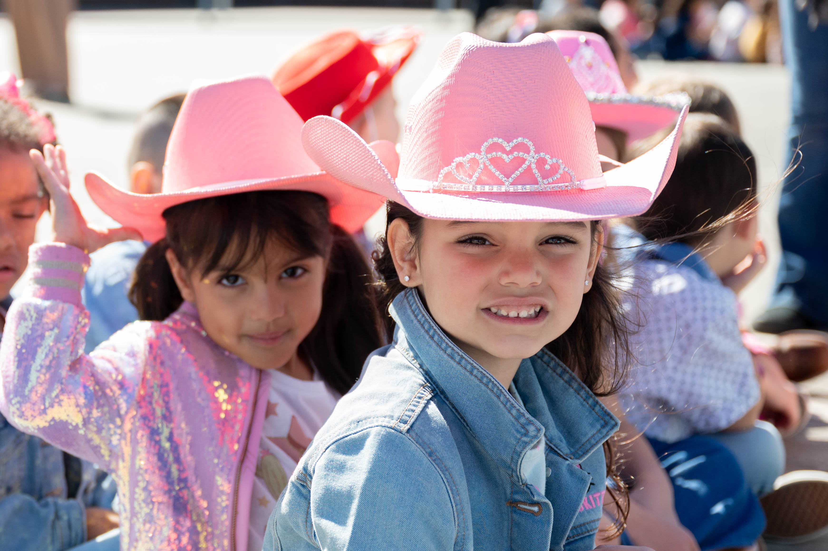 two girls with pink cowboy hats