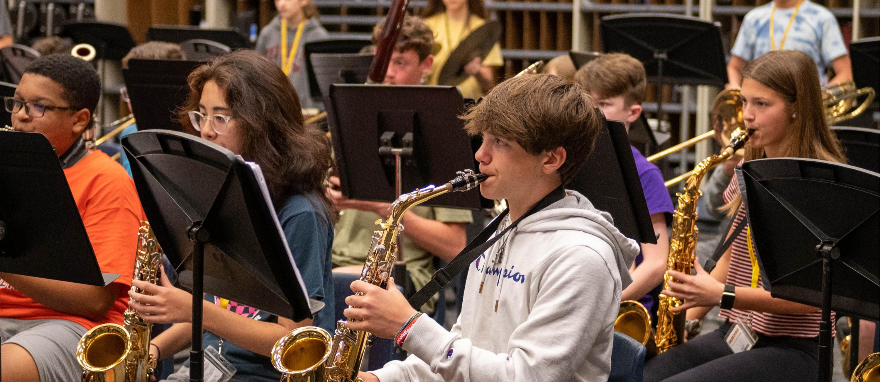 students playing instruments in a band room at a school