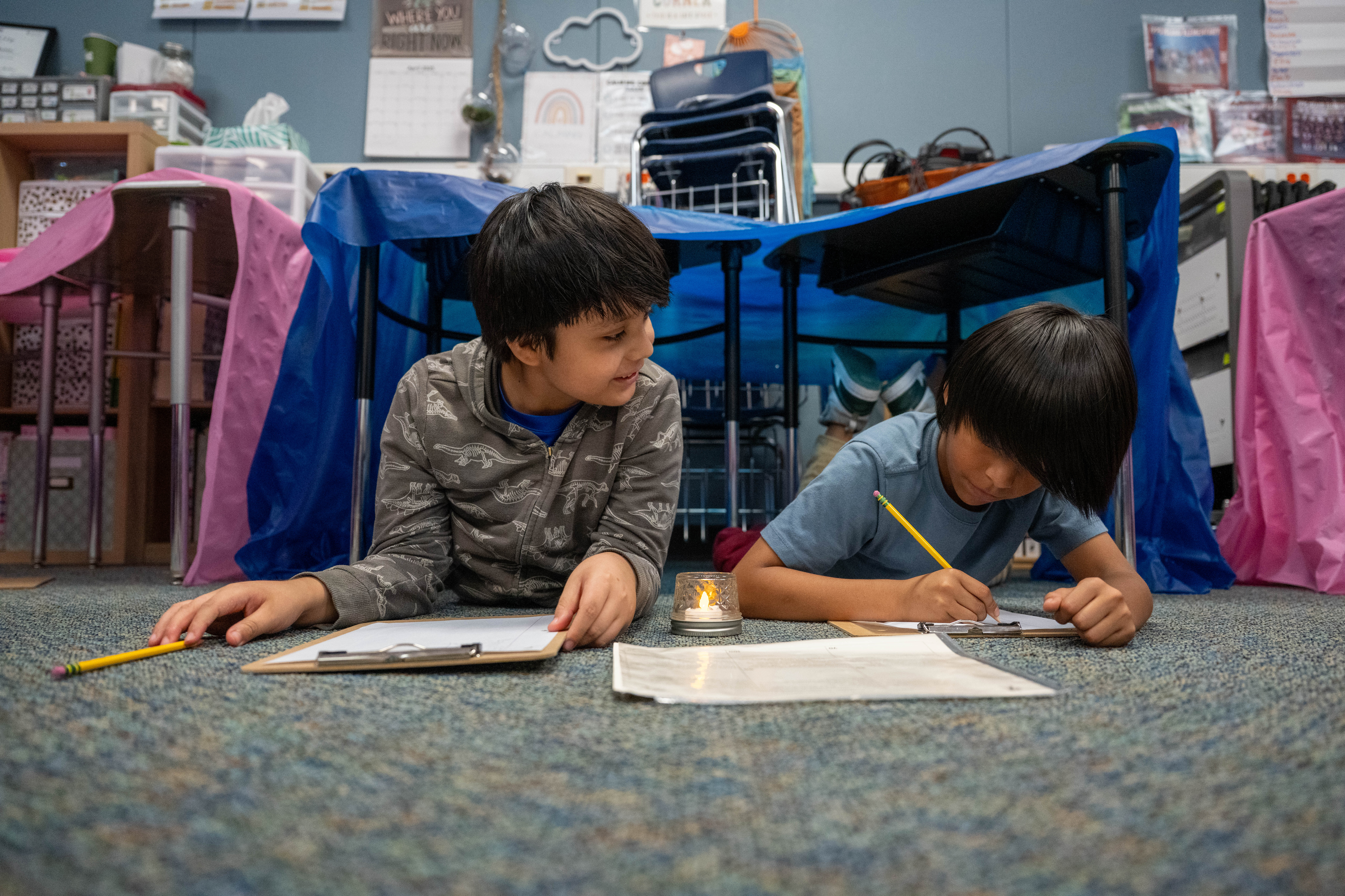 Two boys side by side working on an assignment