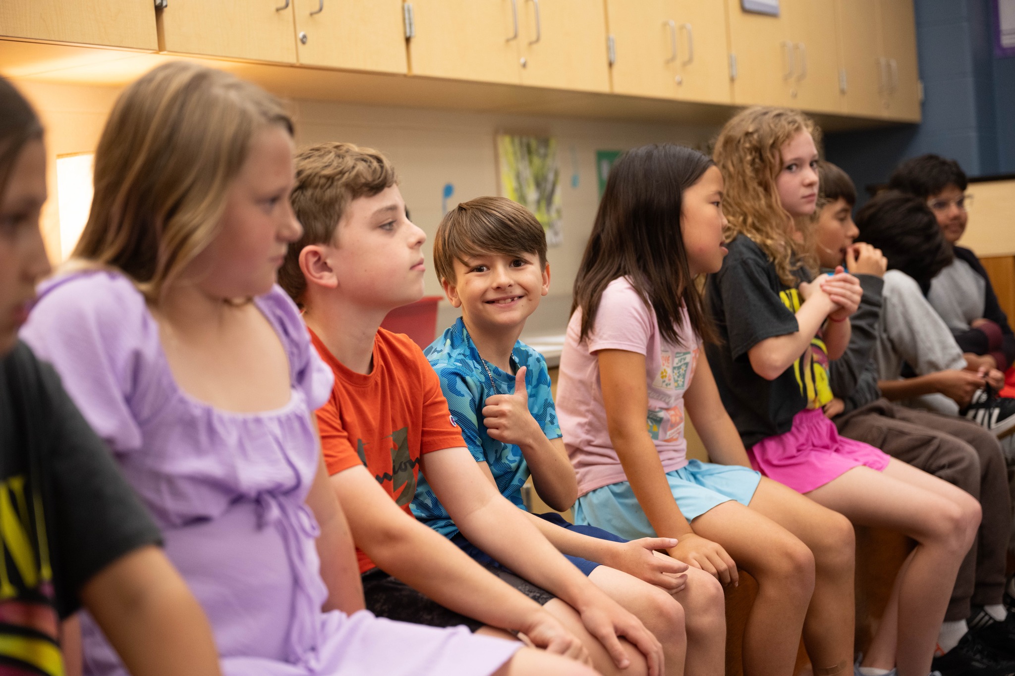 boy smiles at camera in music class