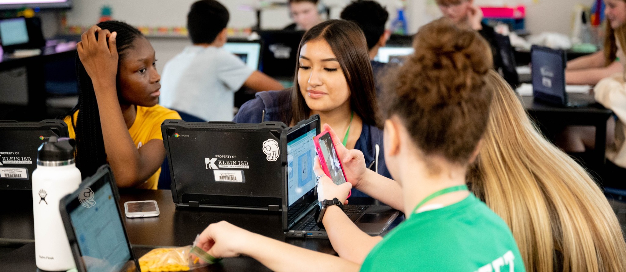 girls smile at laptop