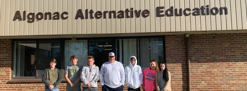 staff and students outside of building