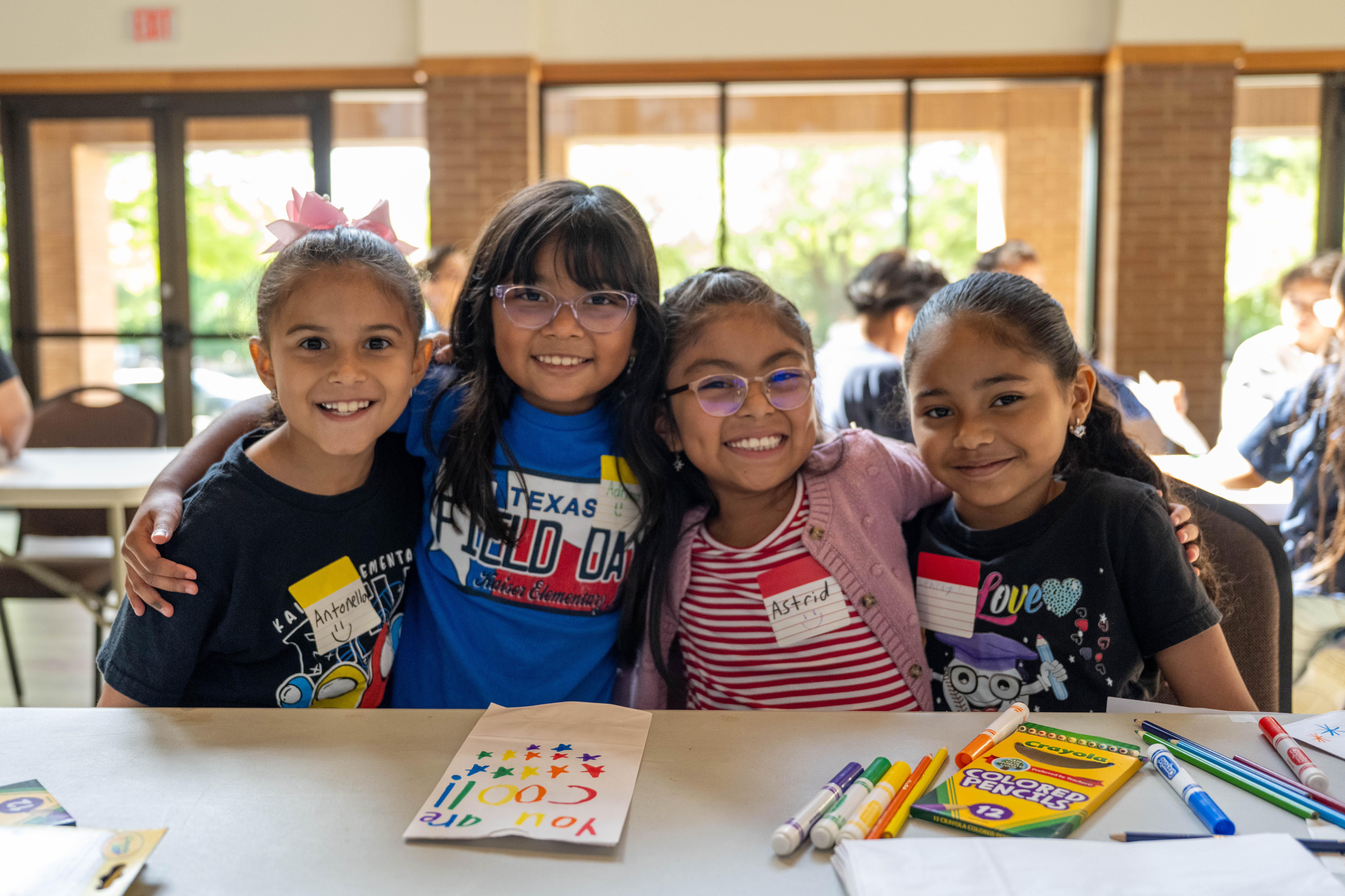 Four students posed smiling next to each other
