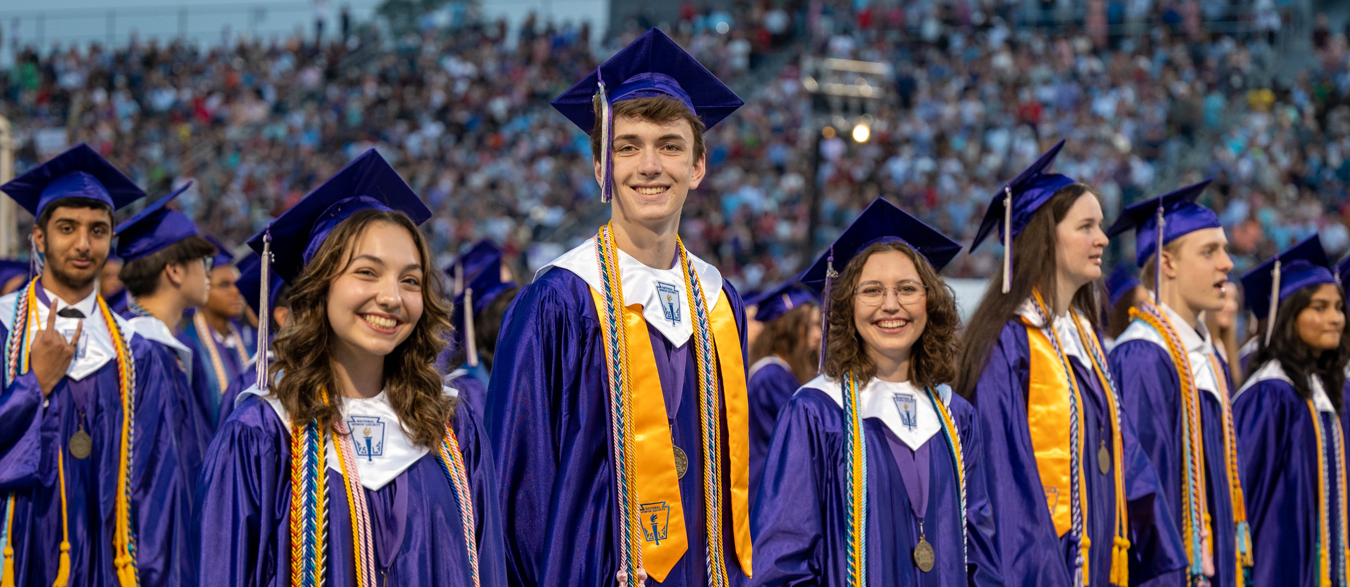 students smiling at graduation