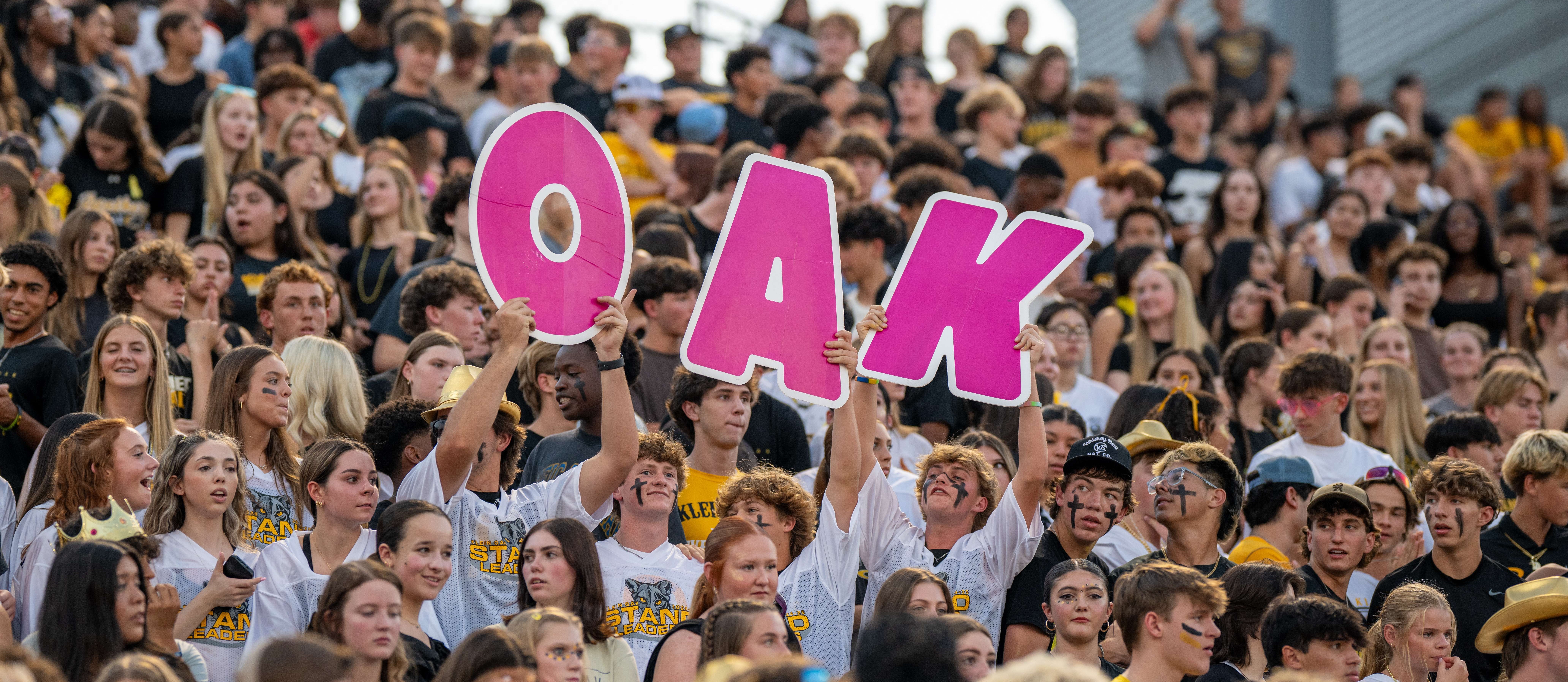 group of kids cheer at football game