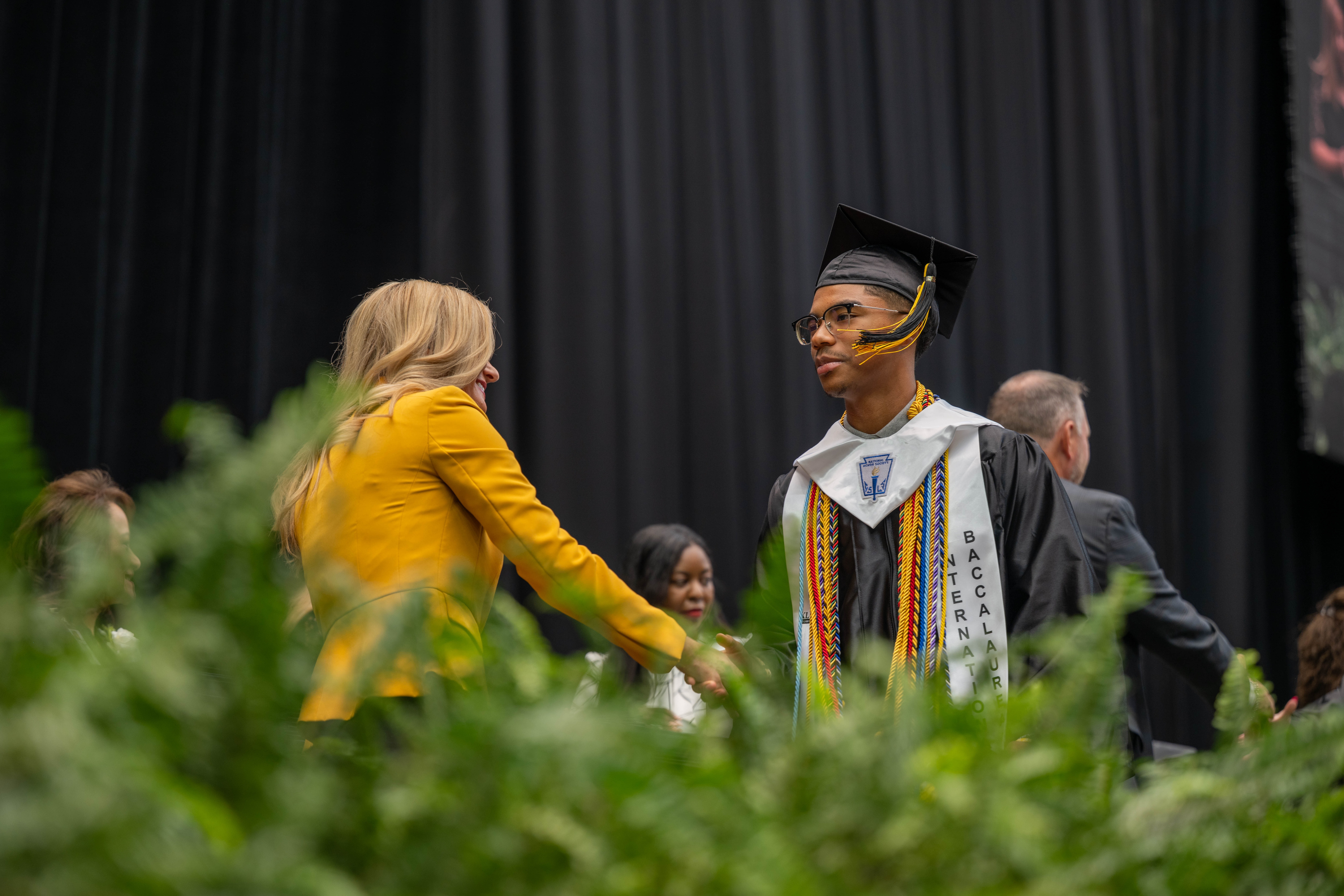 IB Graduating Student Shaking Dr. McGowns hand
