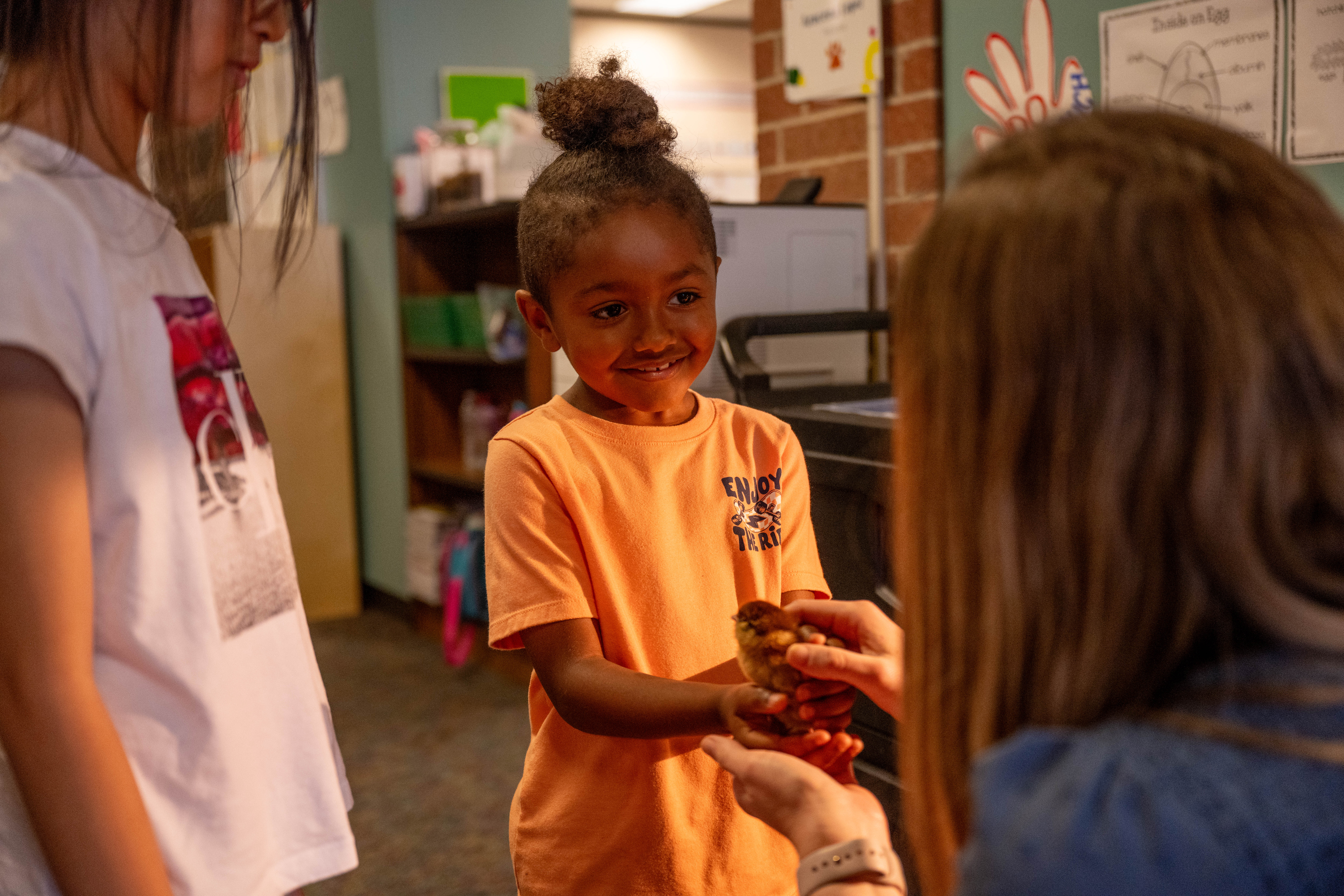 Klenk student holding a baby chick as part of the curriculum