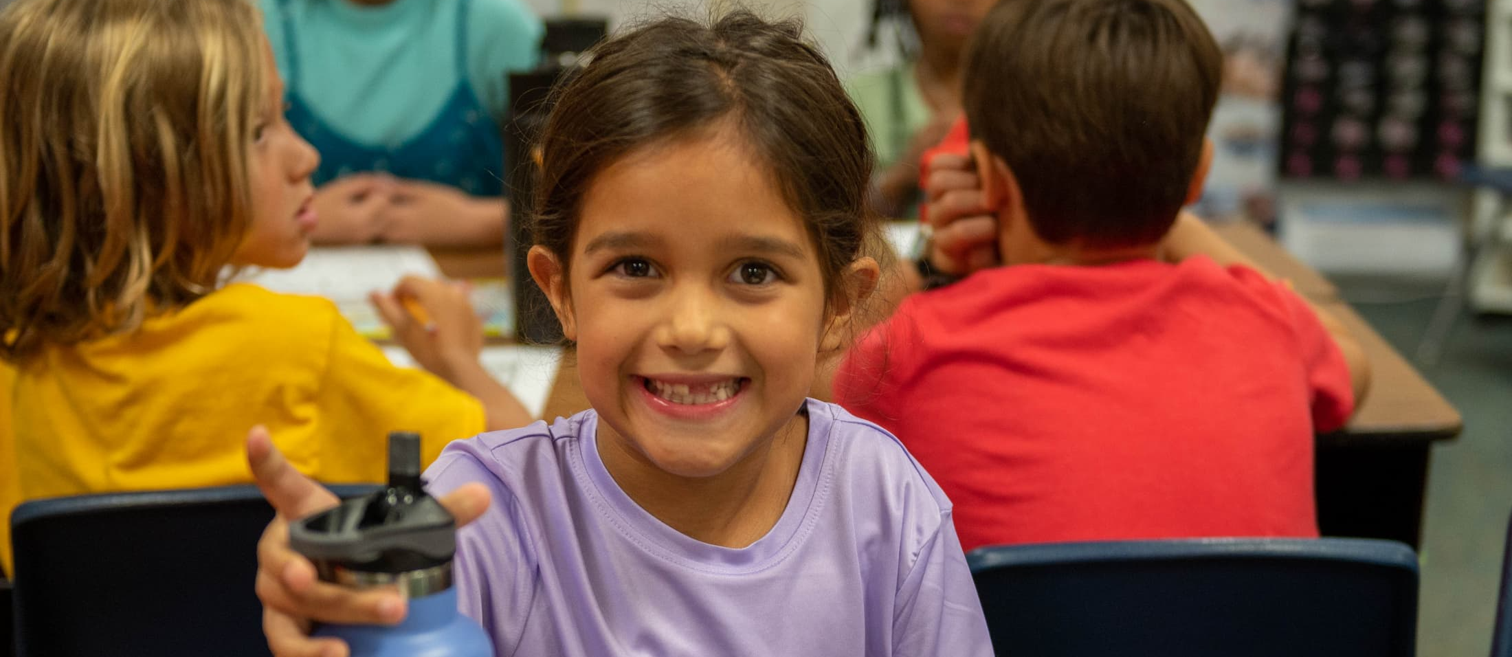 girl smiling with water bottle