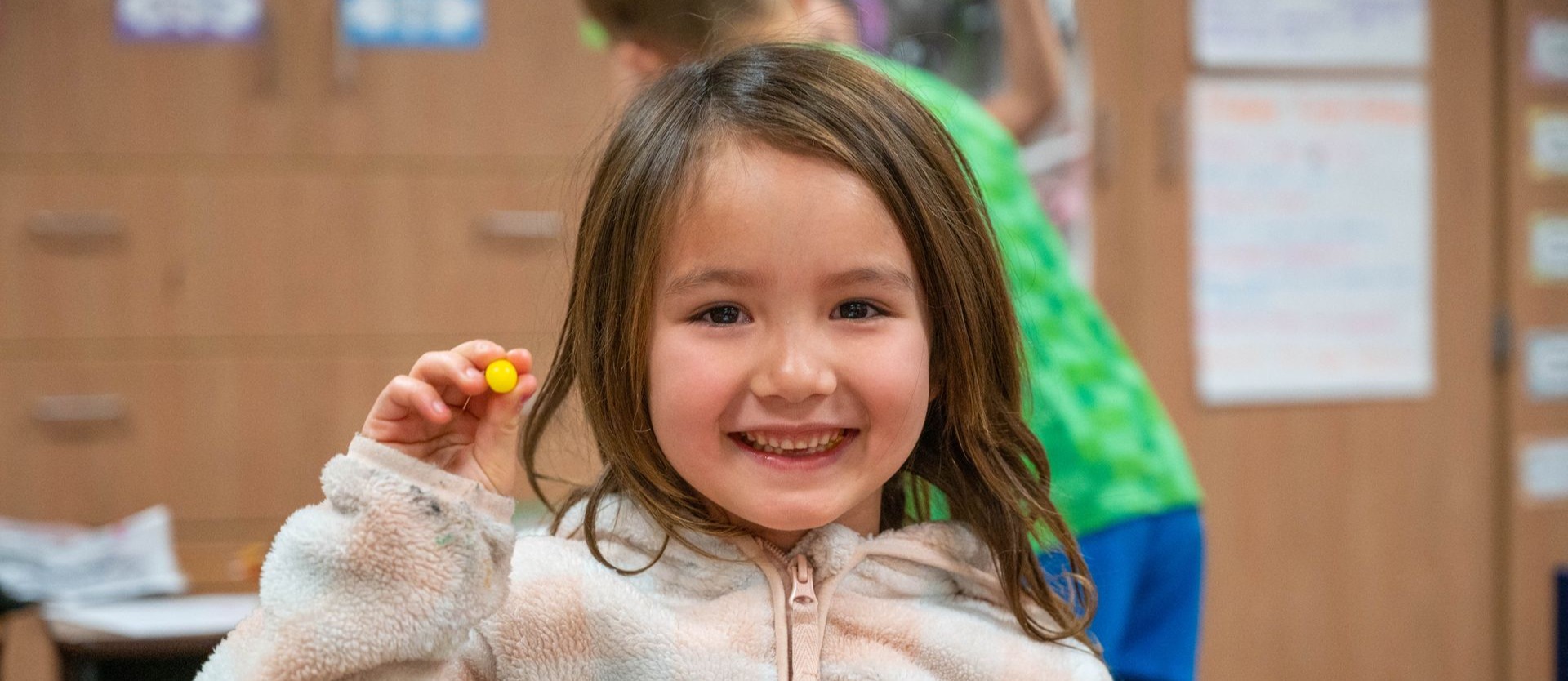 Student smiles at camera