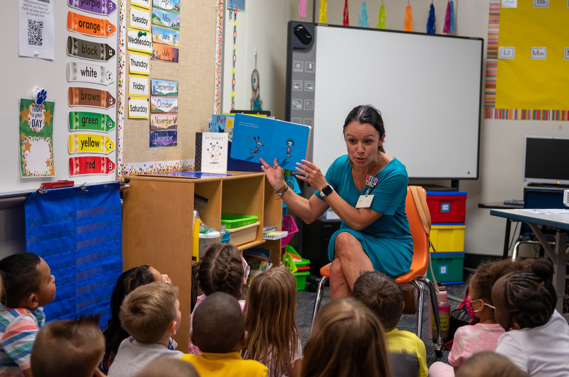 Teacher reading to a group of kids