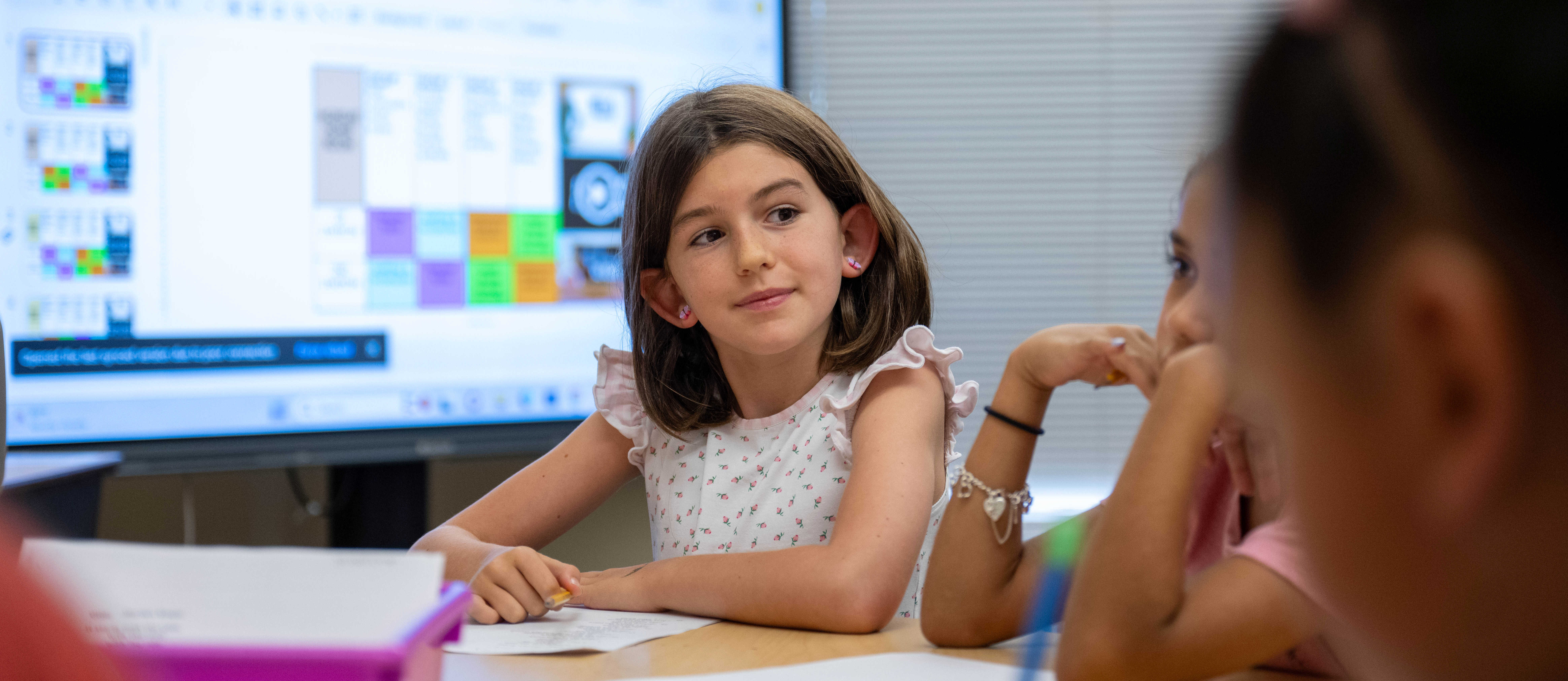 child at classroom table 