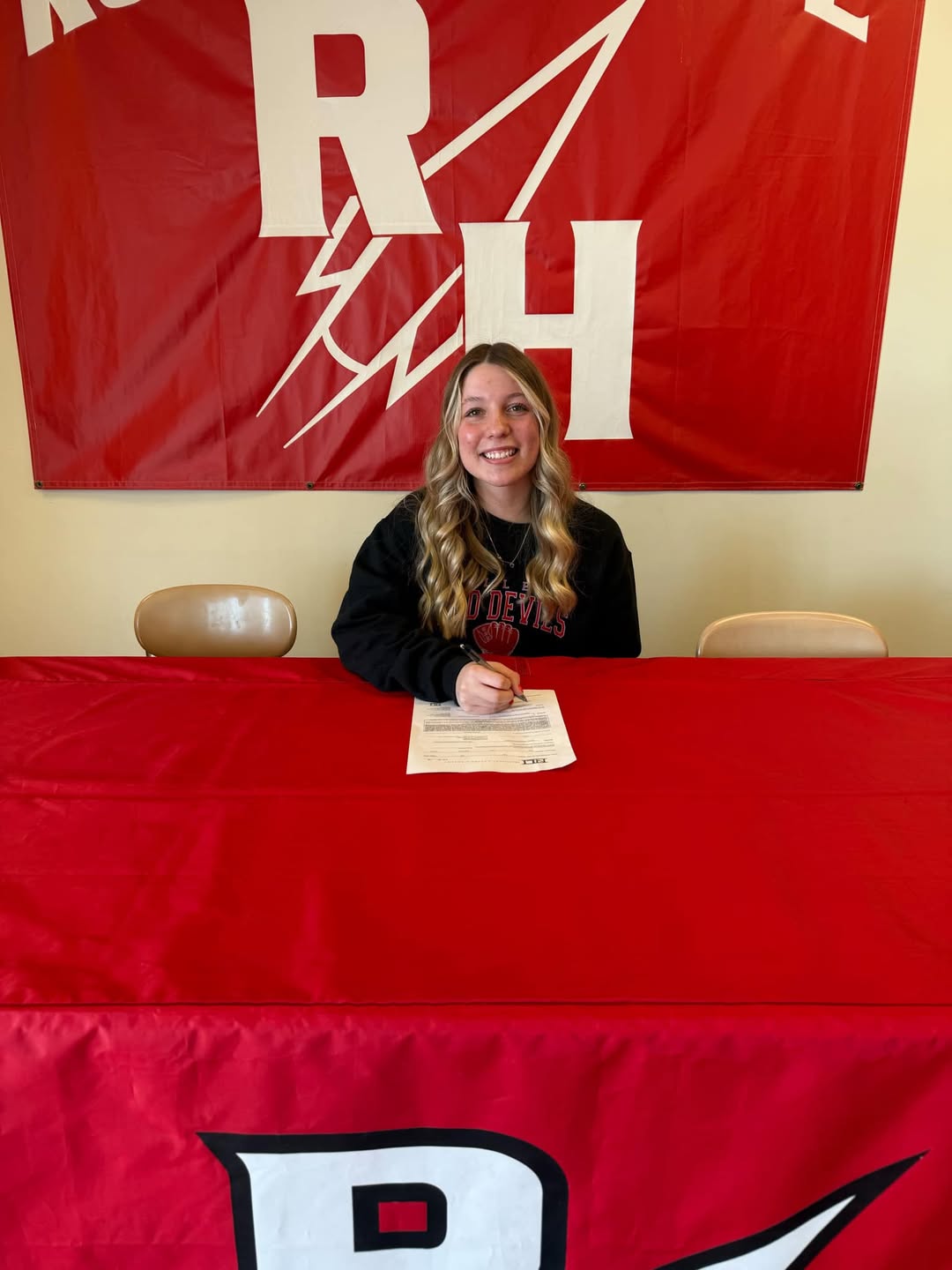 Addie signs her commitment sheet.