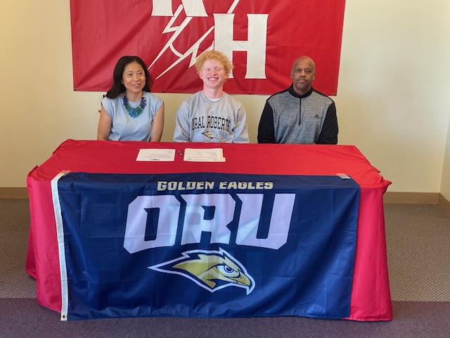 Trey smiling with his parents.