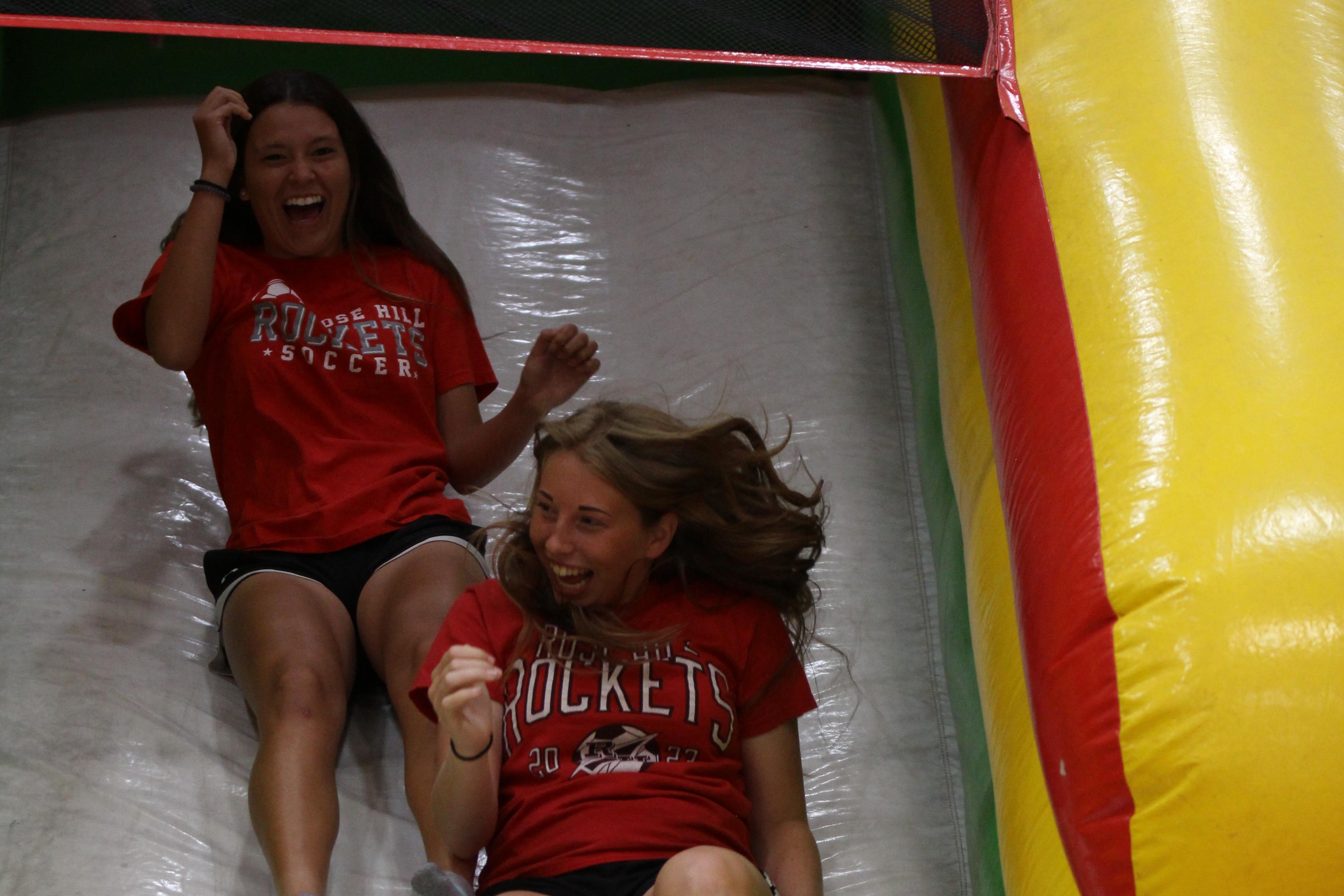 Girls going down the slide.