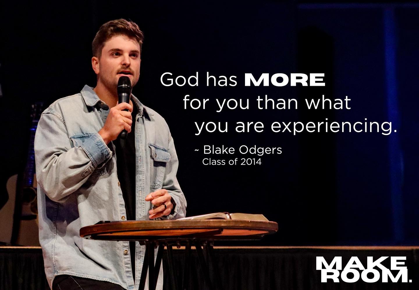 A speaker stands at a podium, delivering a message about faith, with a quote displayed beside him that reads, 'God has MORE for you than what you are experiencing.'
