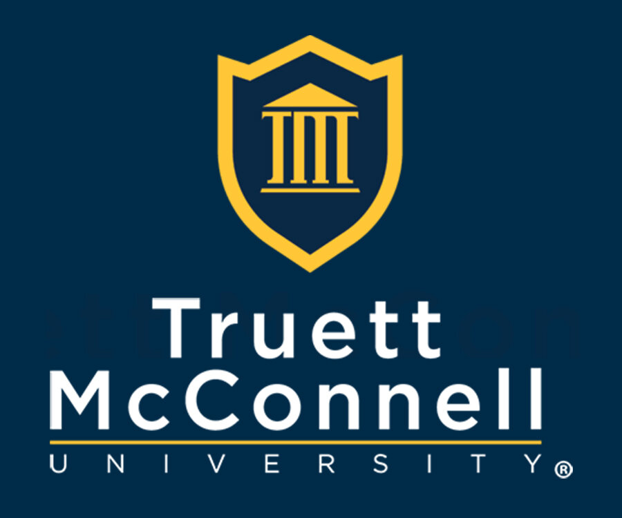 A logo featuring a shield with a classical column design above the text 'Truett McConnell University' in a modern font.