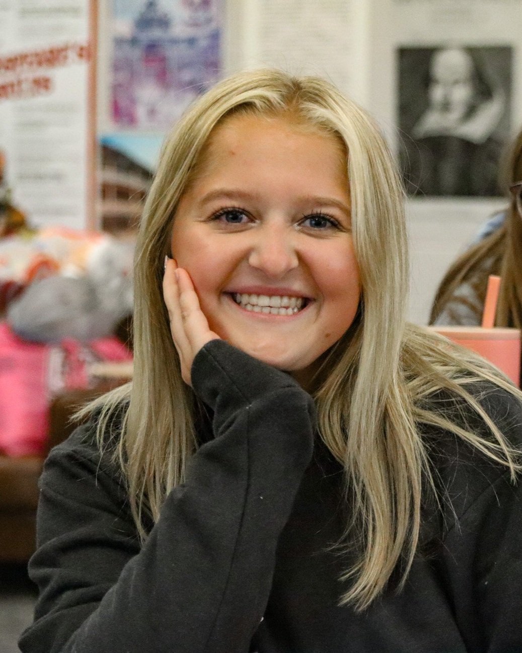 Blonde girl sitting at desk