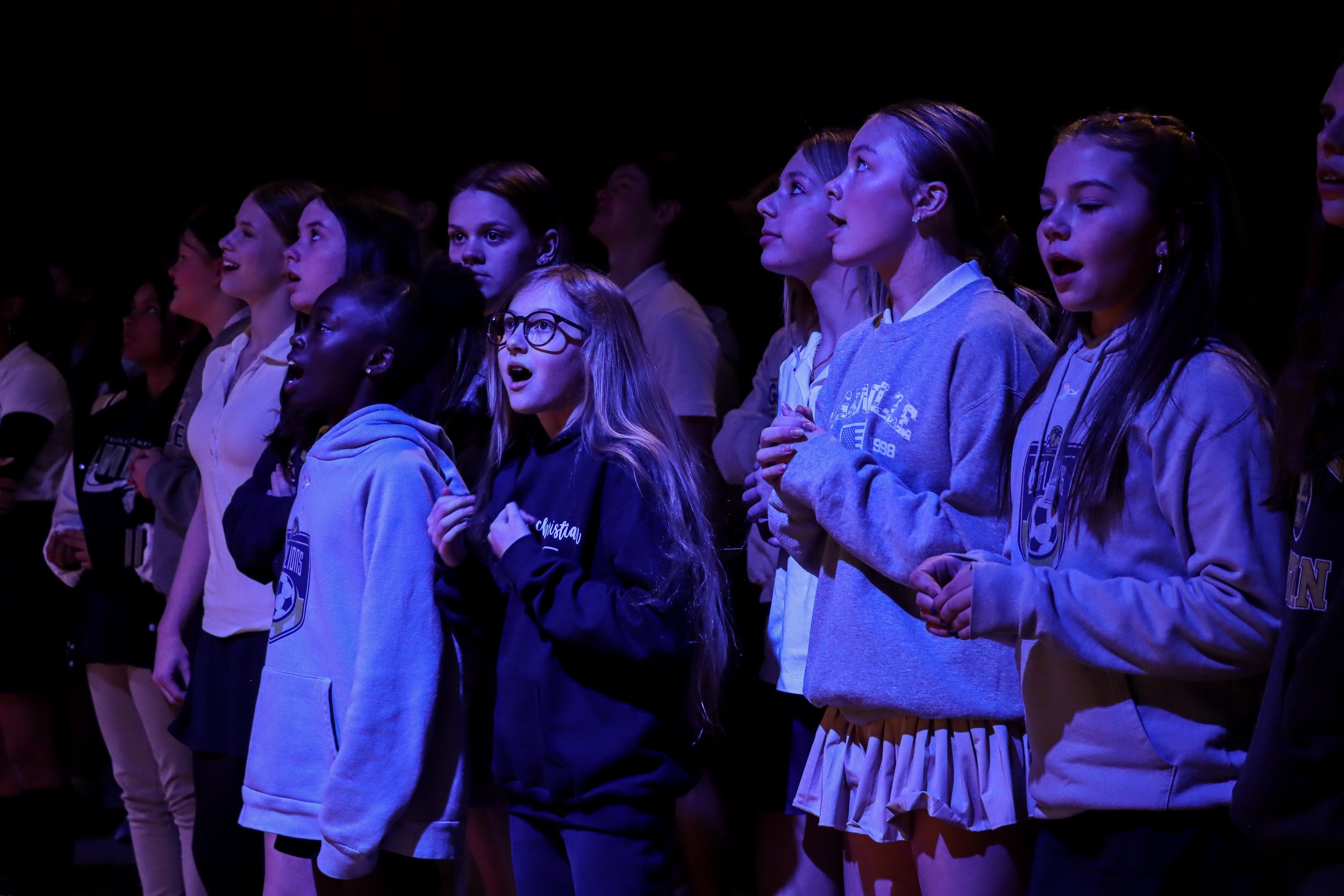 students singing in chapel